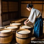 된장의 역사 - A traditional Japanese miso fermentation scene in a rustic rural setting: large wooden barrels fille...